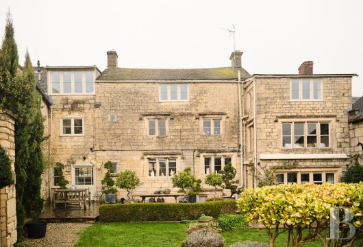 In Painswick, a stone house with enclosed garden and views over the valley